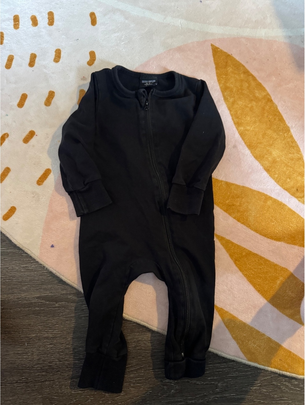 Little Bipsy Collection black one-piece romper in size 9-12 months.
